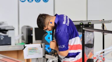 Photo of Isaac competing internationally in the Manufacturing Team Challenge