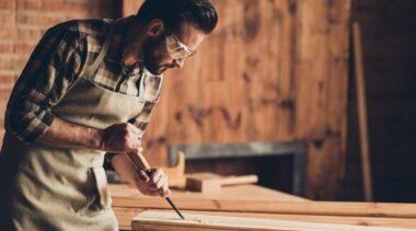 Photo of joiner chiseling a plank of wood