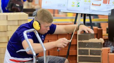 Photo of Lewis competing internationally in the bricklaying competition