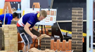 Photo of Lewis competing internationally in the bricklaying competition