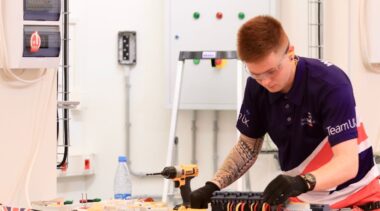 Photo of Thomas competing internationally in the electrical installation competition