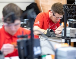 young students soldering