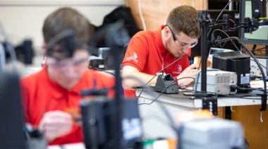 young students soldering