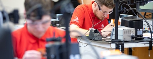 young students soldering