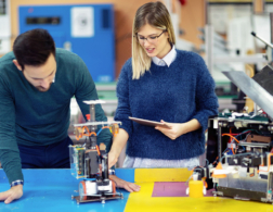 A man and woman looking at machinery