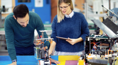 A man and woman looking at machinery