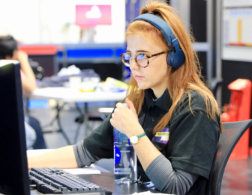 Girl wearing headphones and working at computer