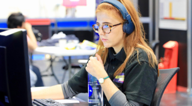 Girl wearing headphones and working at computer