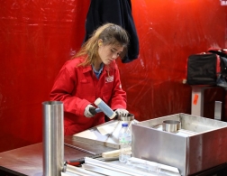 Female competitor hammering metal