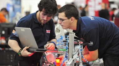 Mark and his teammate Chris looking at a computer