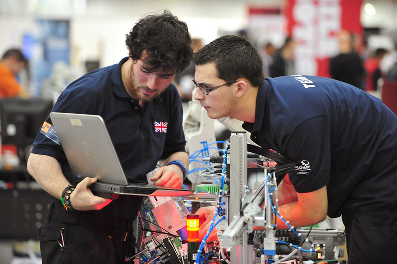 Mark and his teammate Chris looking at a computer