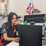 Female competitor focused on computer in engineering competition environment