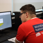 Additive manufacturing student on computer designing