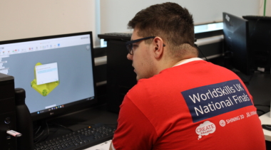 Additive manufacturing student on computer designing