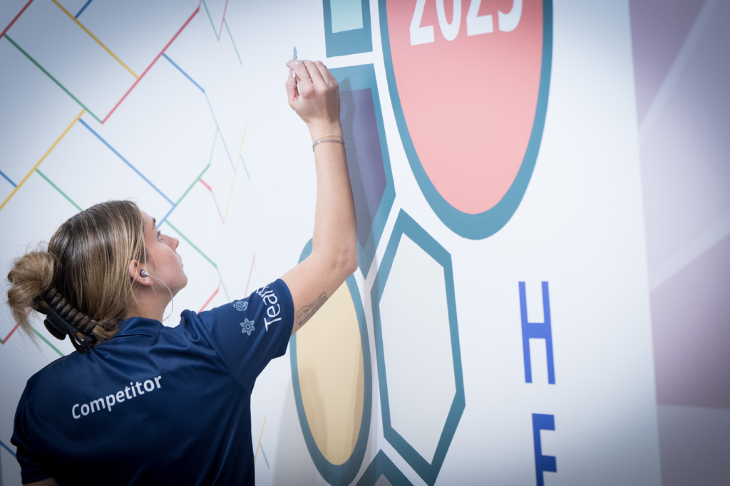 Competitor in action during painting and decorating competition.